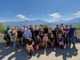 BE-terna team on group hike with scenic mountain view, promoting outdoor team building and healthy work-life balance.