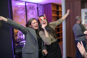 BE-terna colleagues singing karaoke at office party, capturing fun workplace culture and employee celebration moments.