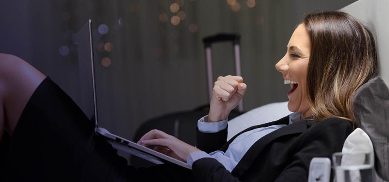 Elevating guest experiences and operations with ERP – business traveler using hotel services digitally
